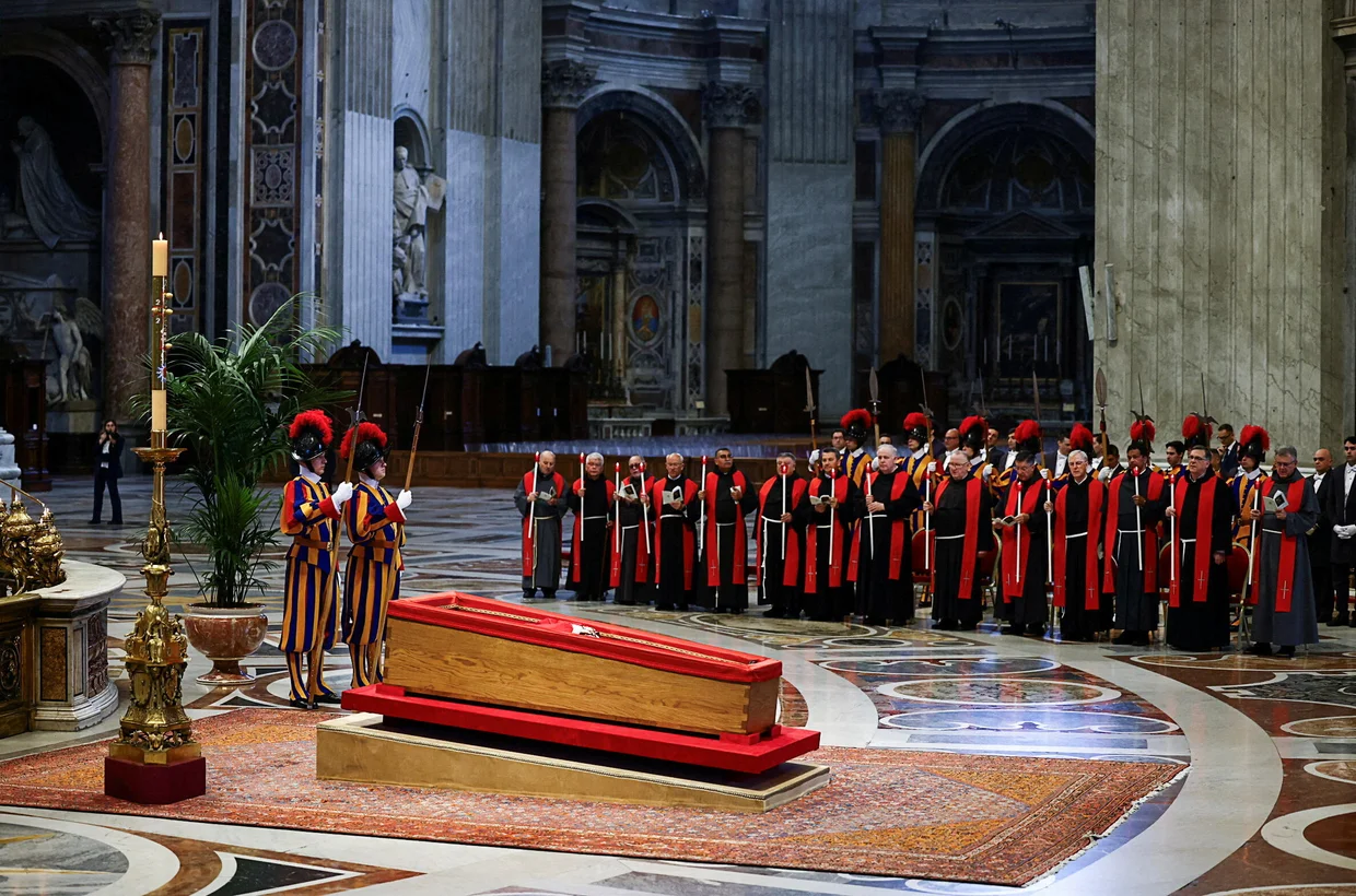 Members of the Swiss Guard stand next to the coffin containing Pope Francis' body, on the day of the translation of his body, in St. Peter's Basilica at the Vatican on April 23, 2025. Yara Nardi / REUTERS