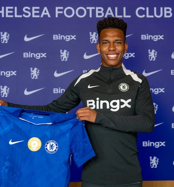 Estevao poses with the Chelsea shirt at Cobham
