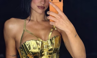 Dua Lipa using the orange iPhone 17 Pro.