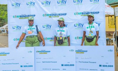 - The three winners of the Corpreneurship Challenge in Lagos pose with their cheques