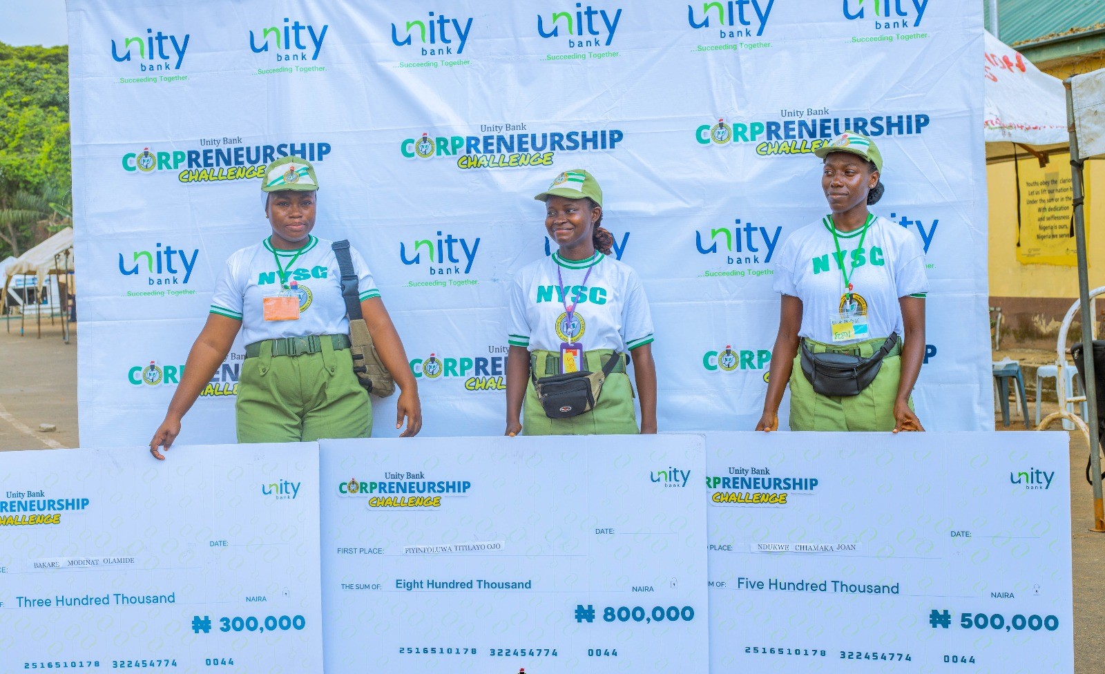 - The three winners of the Corpreneurship Challenge in Lagos pose with their cheques